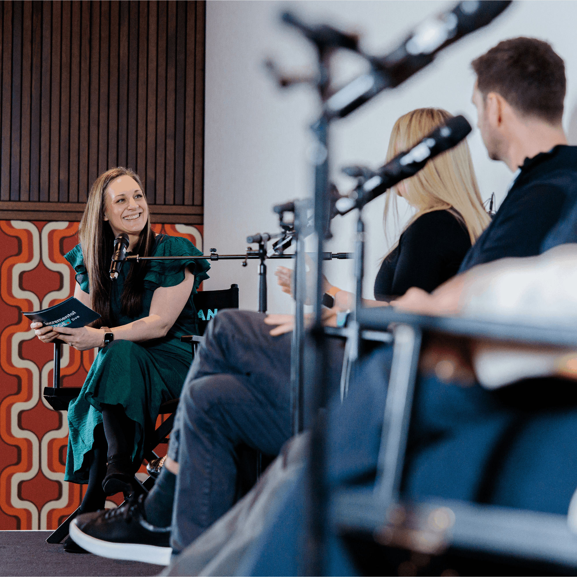 A woman on a panel smiling