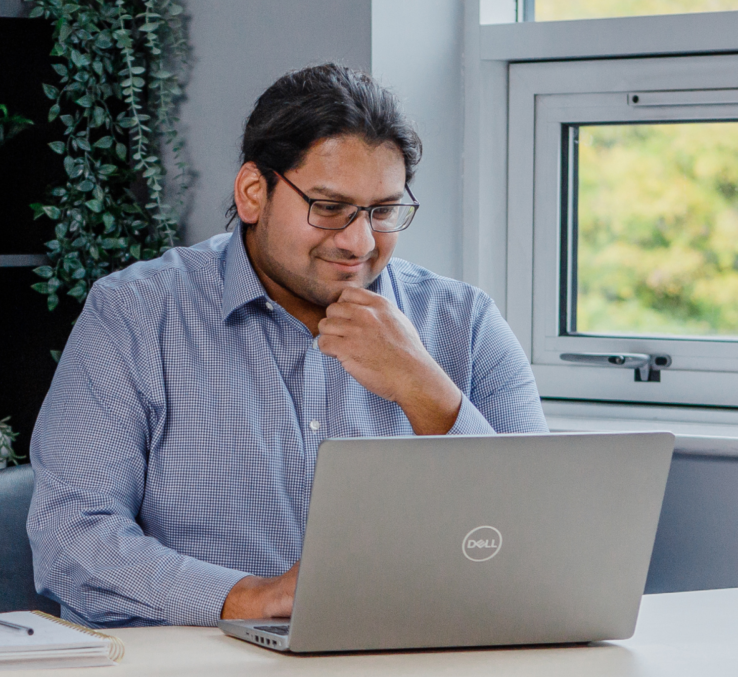 Sajith looking at laptop screen