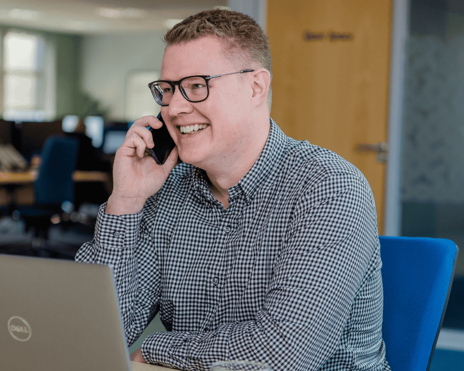 CA smiling Datel Sage Intacct consultant speaking to a customer over the phone