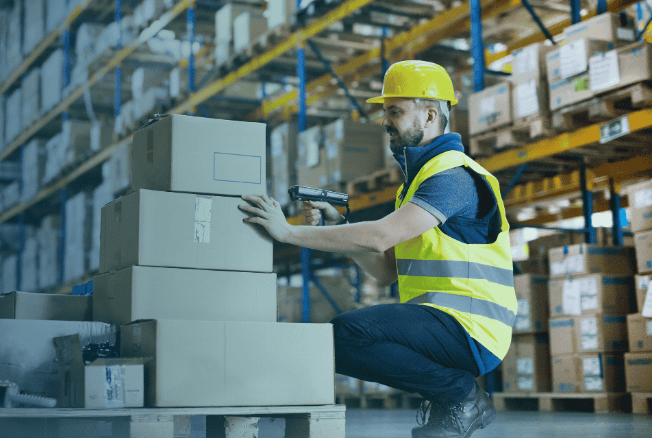 Man in a high-vis holding boxes