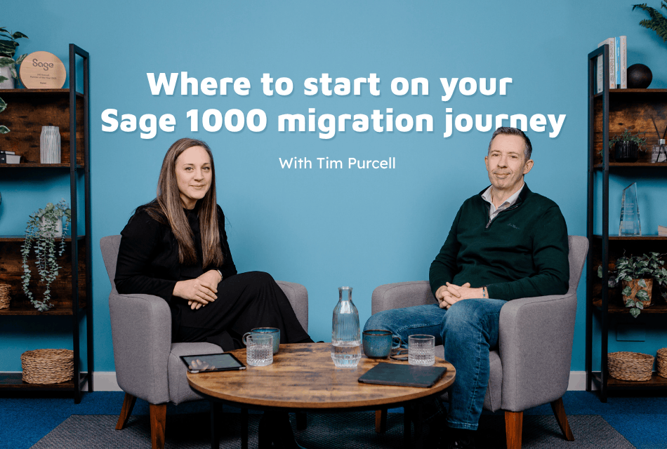 A man and woman sat in chairs smiling