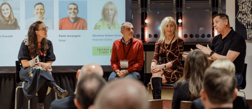 Two women and two men sat on stage at a panel
